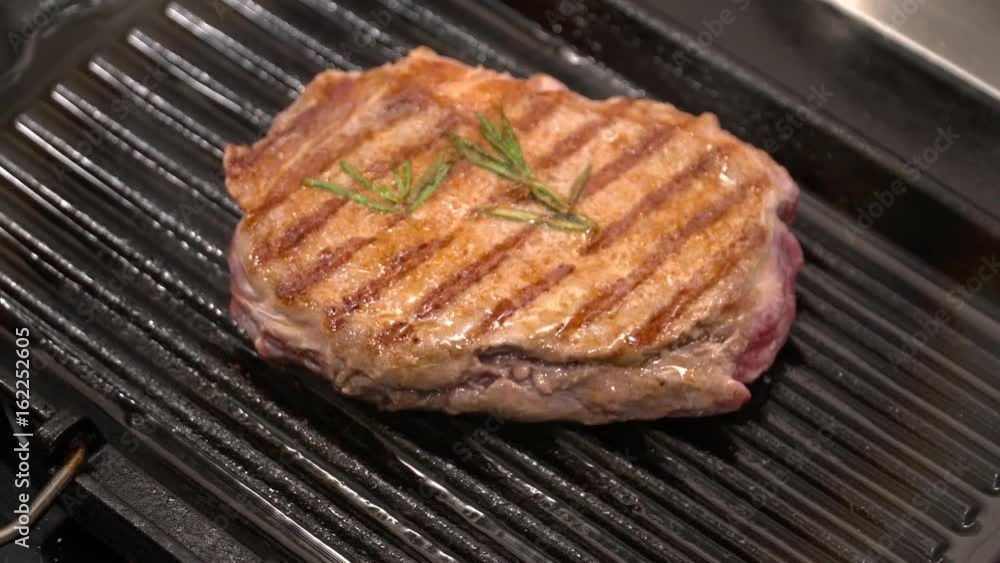 Closeup of tasty grilled steak on the grill pan Closeup of tasty grilled steak on the grill pan