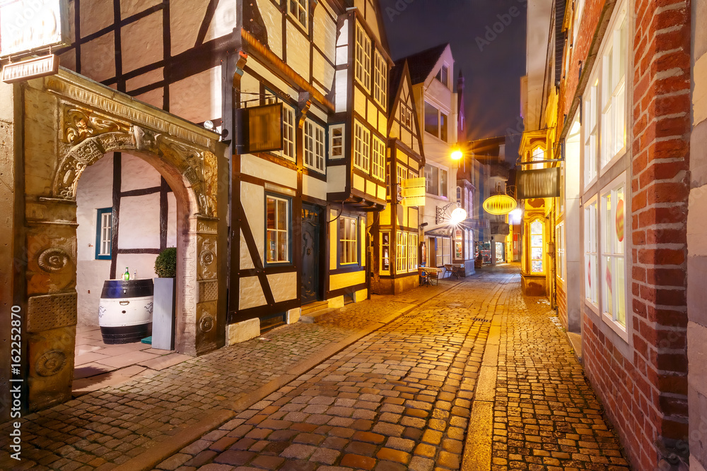 Medieval Bremen street Schnoor with half-timbered houses in the centre of the Hanseatic City of Bremen at night, Germany