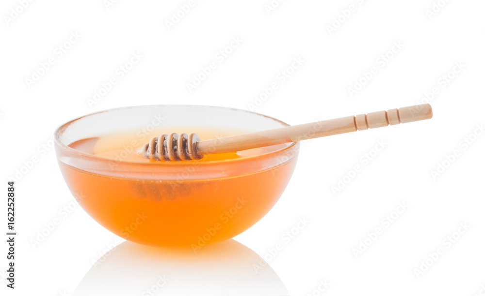 Wooden dipper with bowl of honey, isolated on the white background Wooden dipper with bowl of honey, isolated on the white background