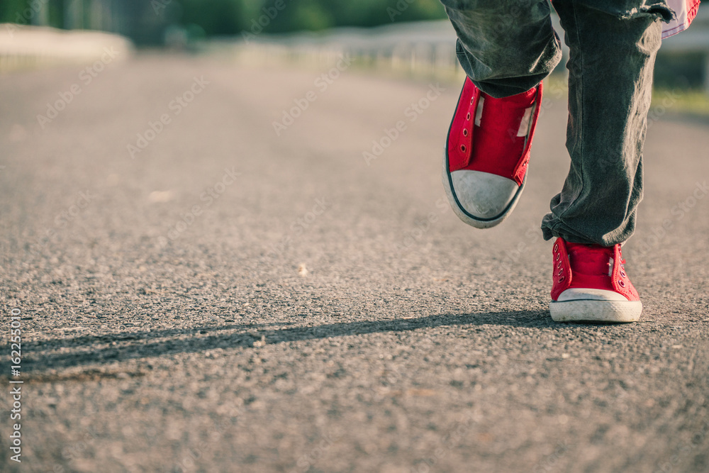 child wear red shoes running on the street,selective focus and vintage tone child wear red shoes running on the street,selective focus and vintage tone