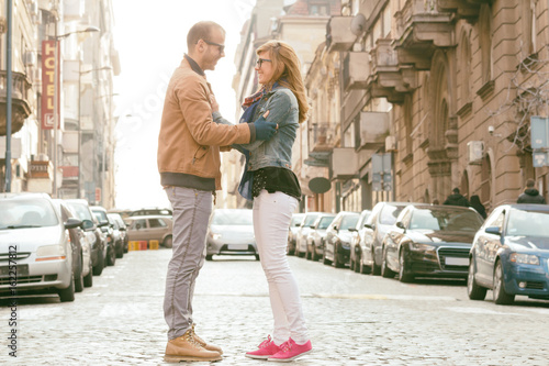 Young urban couple posing on the street.