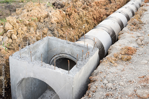 Concrete drainage pipe and manhole in construction site.