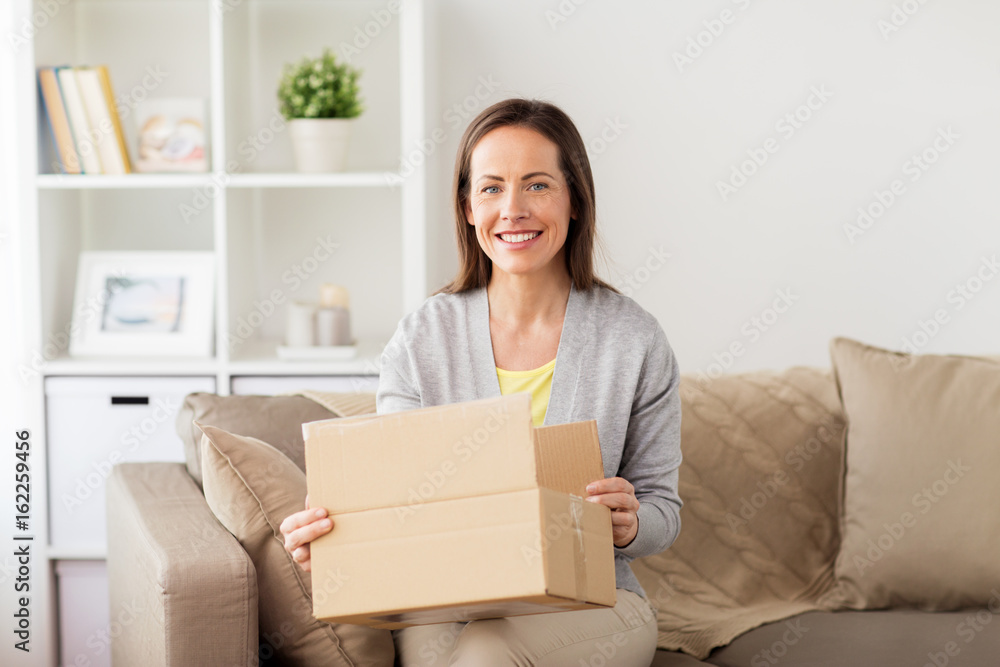 smiling woman opening cardboard box smiling woman opening cardboard box