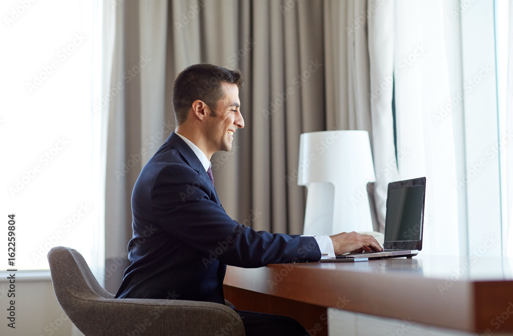 businessman typing on laptop at hotel room businessman typing on laptop at hotel room