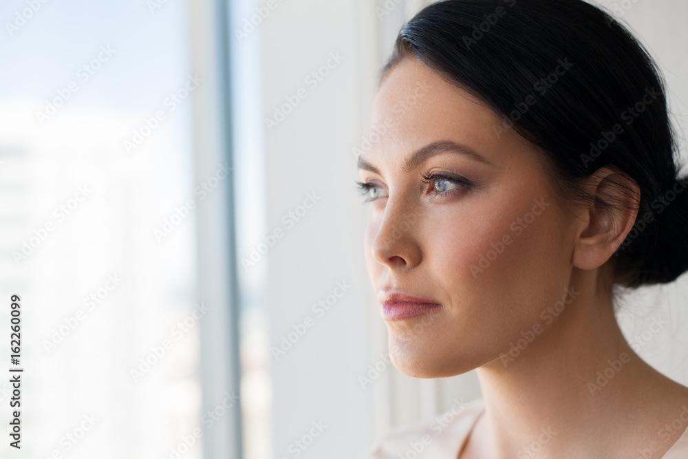 close up of woman looking through window