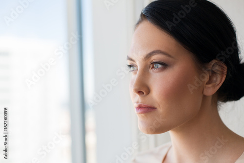 close up of woman looking through window