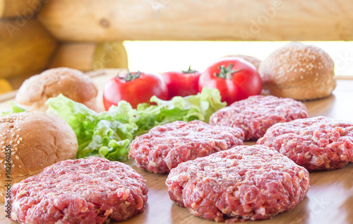 The raw ingredients for the homemade burger on country background.