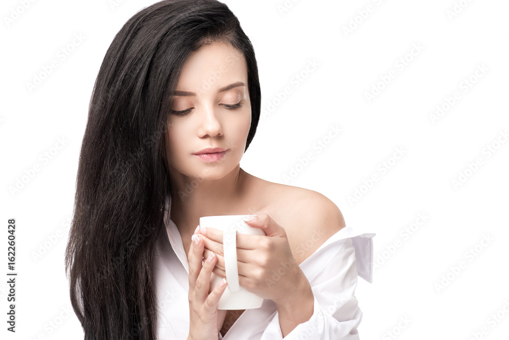 Attractive young woman holding cup with hot beverage isolated on white Attractive young woman holding cup with hot beverage isolated on white