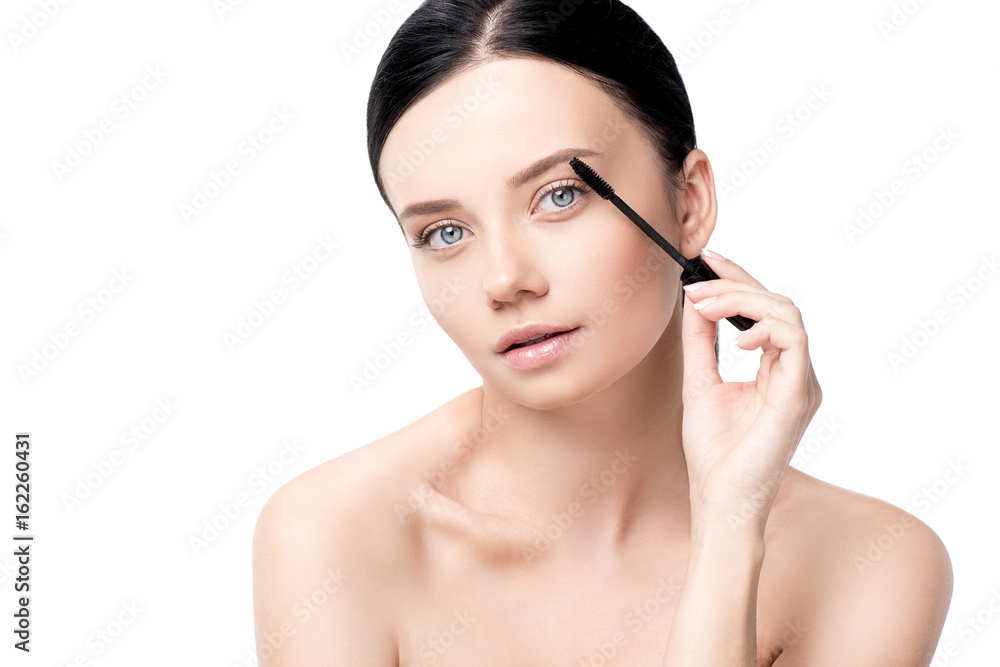 tender naked brunette woman applying mascara isolated on white tender naked brunette woman applying mascara isolated on white