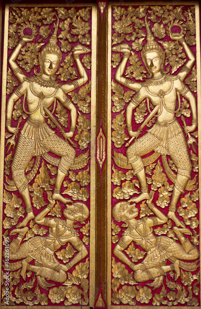 Thai fine art on the wooden temple door at Chiang Mai province 