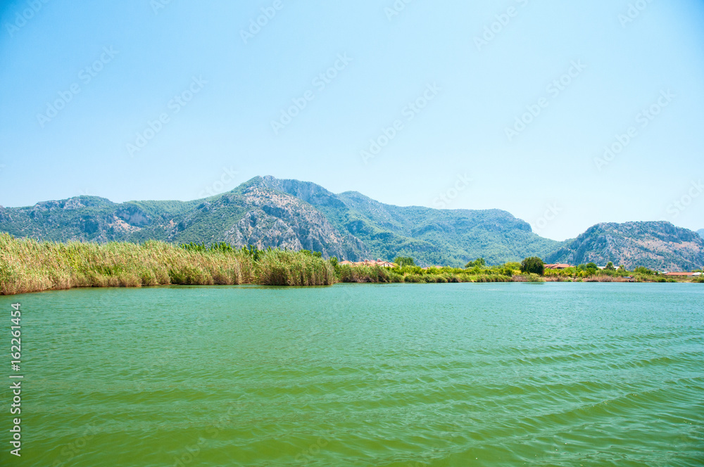 The Dalyan River with tourist boat in the straits of the river