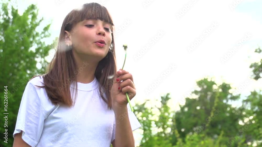 Teen girl blowing dandelion. Slow motion 240 fps. High speed camera shot. Full HD 1080p. Teen girl blowing dandelion. Slow motion 240 fps. High speed camera shot. Full HD 1080p.