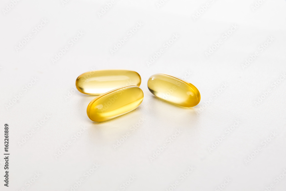 yellow pills on white background yellow pills on white background