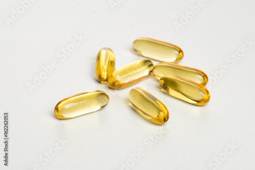 yellow pills on white background