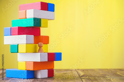 Vászonkép Business metaphor of businessman climbing colorful career stairs on yellow background