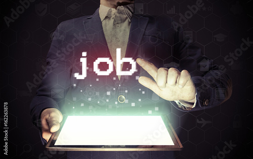 Image of a man with a tablet in his hands. His hand touches the "job" button. Online job search concept.
