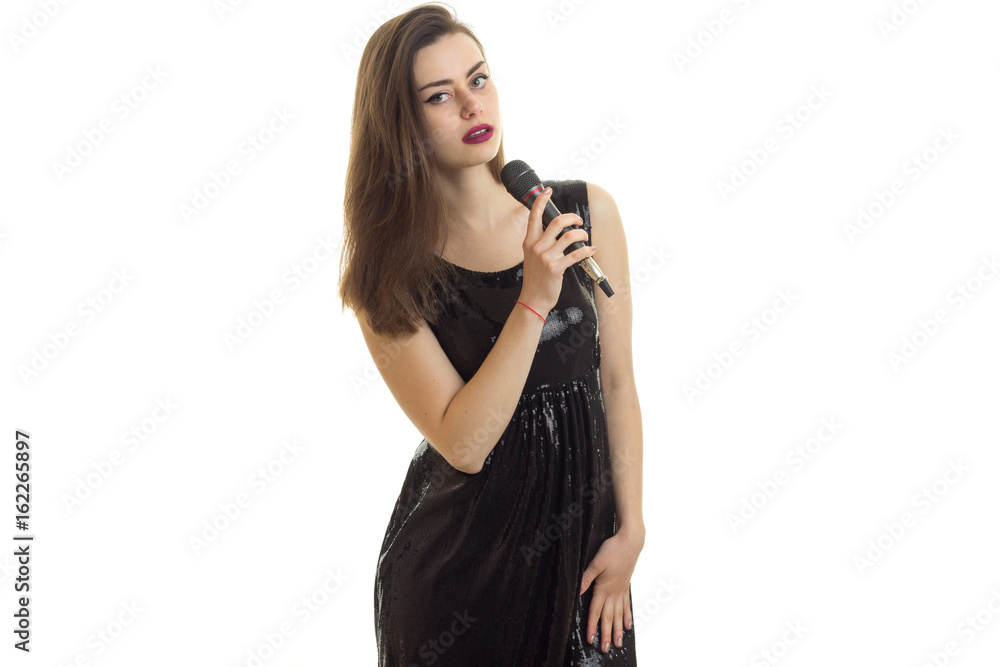 beautiful young girl in black dress holding a microphone beautiful young girl in black dress holding a microphone