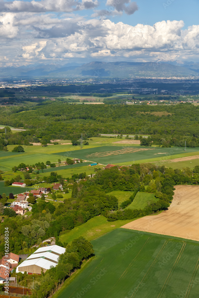 Landscape mountains, village houses. A view of the earth from the sky. Shooting from the Copter Mountain Jura. France