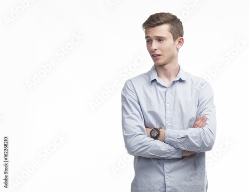 Young dissatisfied man portrait of a confident businessman on a gray background. Ideal for banners, registration forms, presentation, landings, presenting concept.