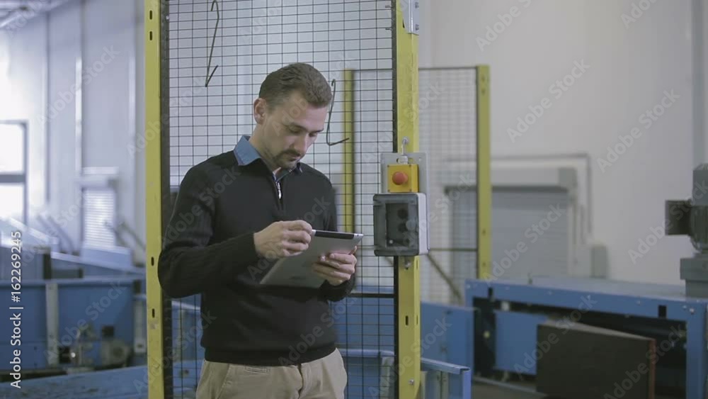 Young airport employee uses tablet Young airport employee uses tablet