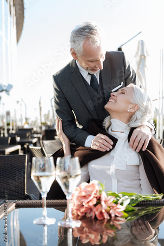 Vertical photo of delighted couple that enjoying the moment