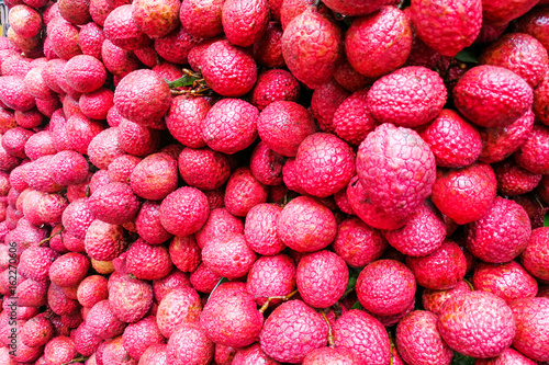 Close-up on heap group of lychee fruits tied together