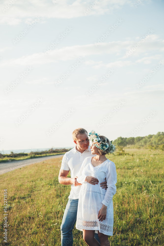 beautiful pregnant girl and her husband in the nature beautiful pregnant girl and her husband in the nature