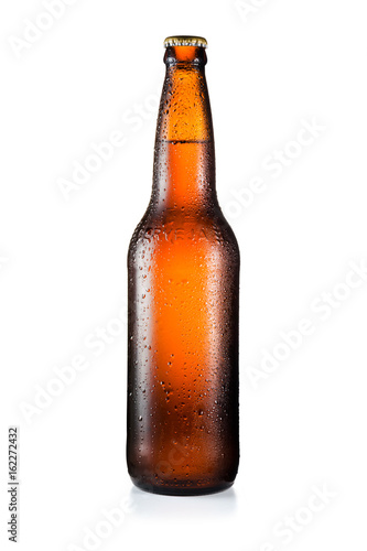 Bottle of beer with drops isolated on white background