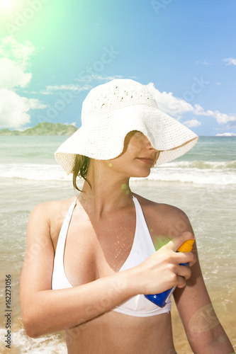 Woman applying sun lotion