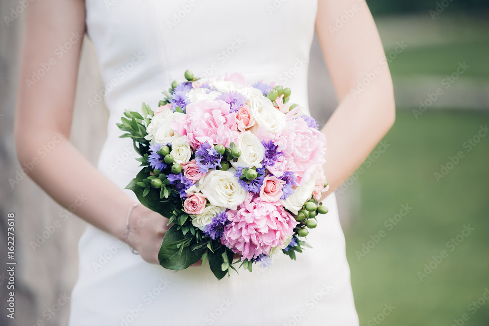 bride's hands hold beautiful wedding bouquet bride's hands hold beautiful wedding bouquet