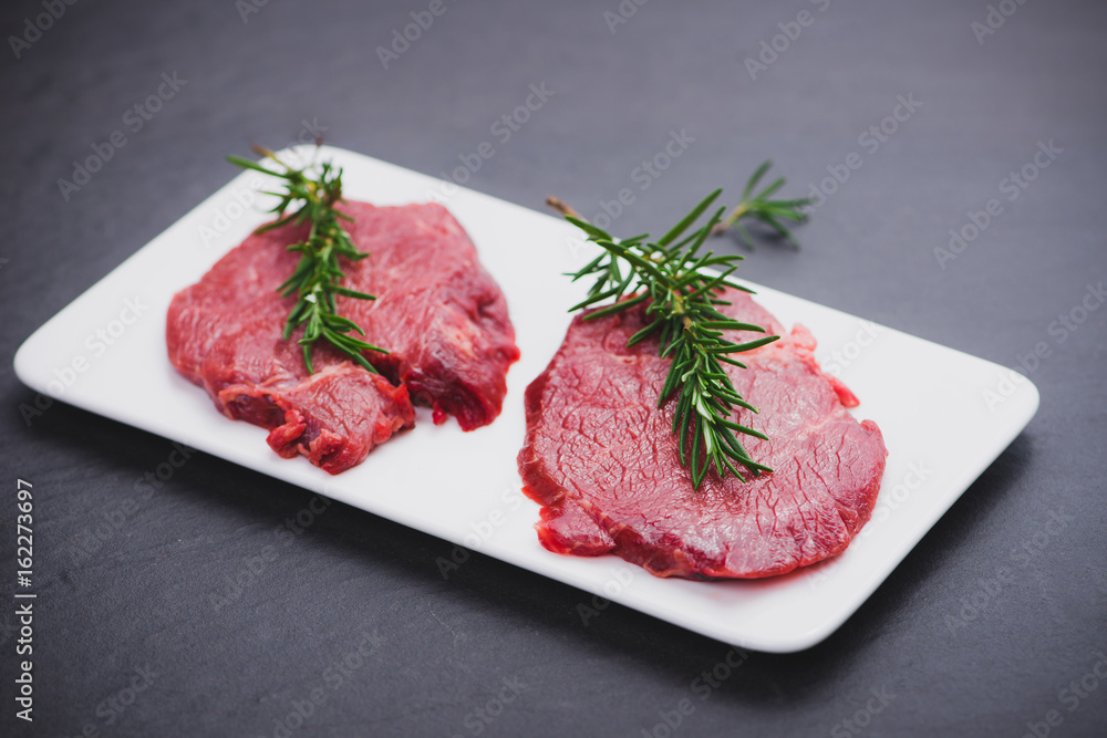 Raw beef meat sliced on a plate Raw beef meat sliced on a plate