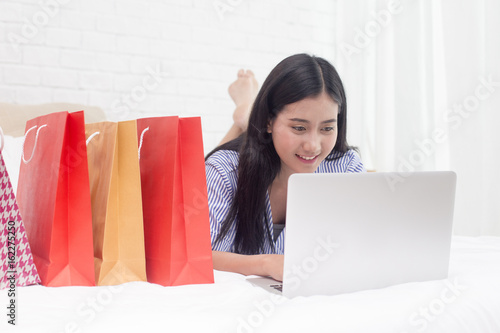 Beautiful asian women using craditcard for shopping online with laptop, online shopping protrait concept. photo