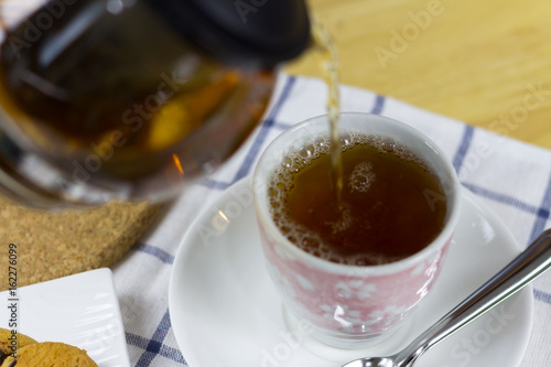 Man Pouring tea in house 