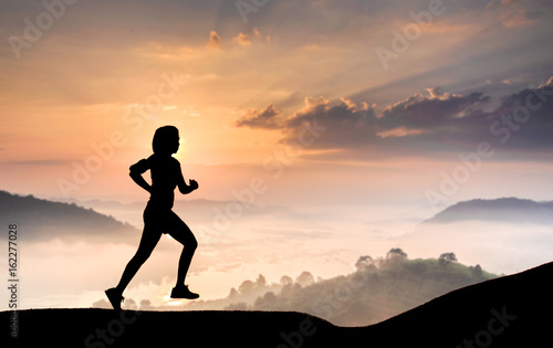silhouette runner women exercise during morning time landscape background