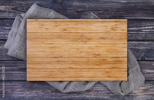 Fototapeta Serving tray over old wooden table, cutting board on dark wood background, top v