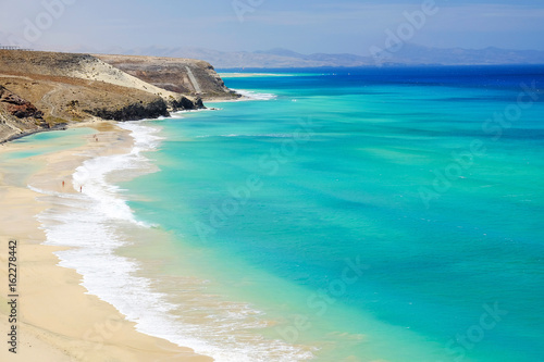 Beach with amazing water colors on Fuerteventura, Spain. © Elena Krivorotova