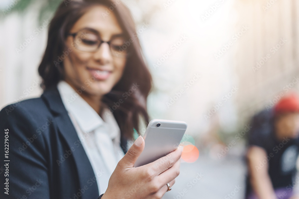 Close up of female employer hands using modern smartphone outdoors, Business woman reading the message via cell phone while going to office