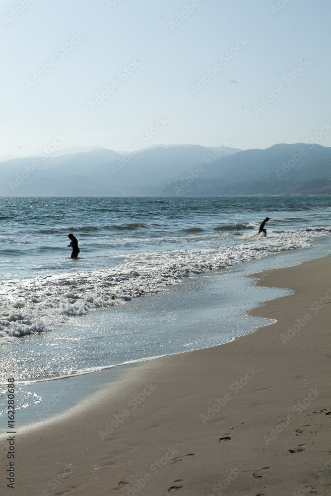 Quiet California beach with people