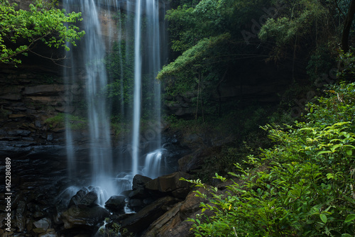 Fototapeta Naklejka Na Ścianę i Meble -  Waterfall at deep tropical forest, Waterfall inpact stone