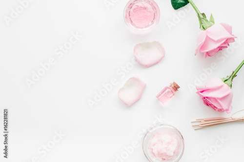 homemade spa with rose cosmetic set, cream, salt and oil on white background top view mock-up