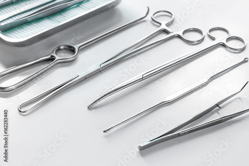 Medical instruments for cosmetic surgery on white table backgrond