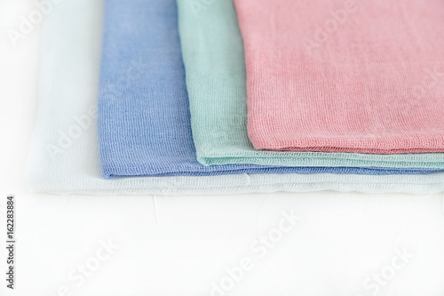 A shelf in a store, cotton fabric of pastel colors.