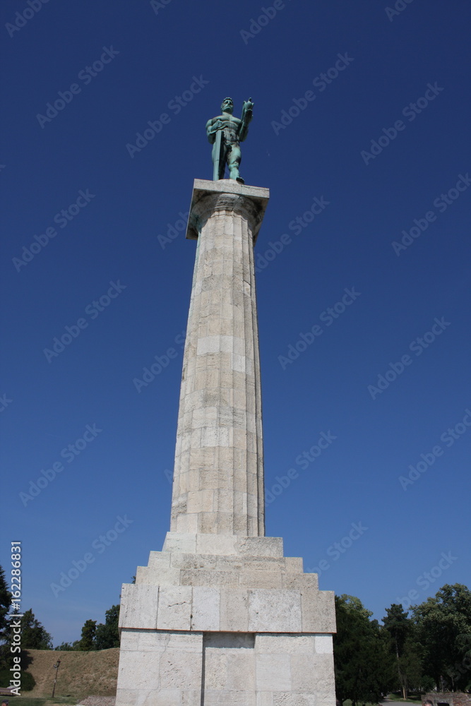 Monument sculpture of the Belgrade Victor made of bronze, located in Kalemegdan park facing the Sava River and Zemun district, Belgrade, Serbia.