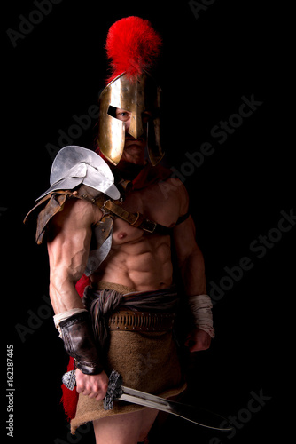 gladiator posing isolated in dark photo