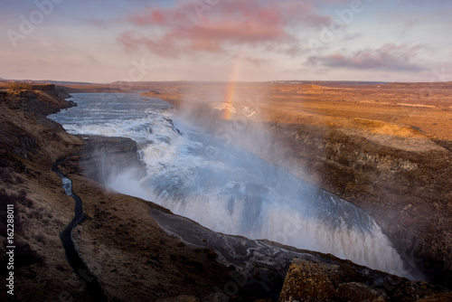 Gullfoss waterfall in Iceland Sunset with Rainbow and cloudy day