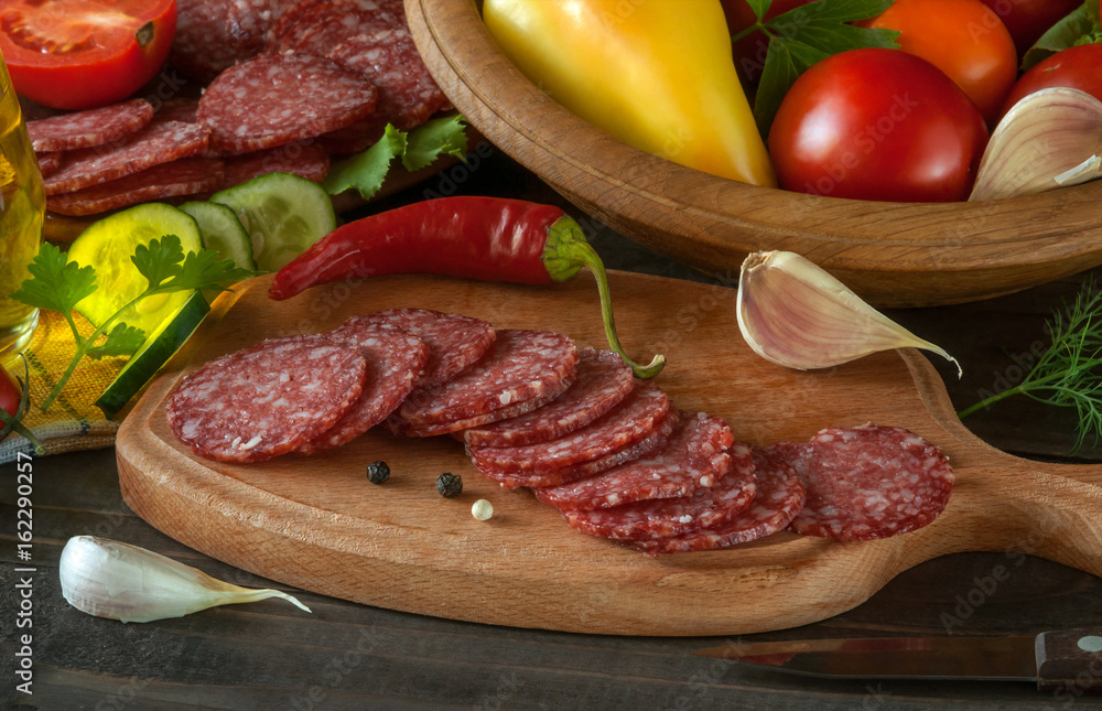 Slices of salami on a wooden table