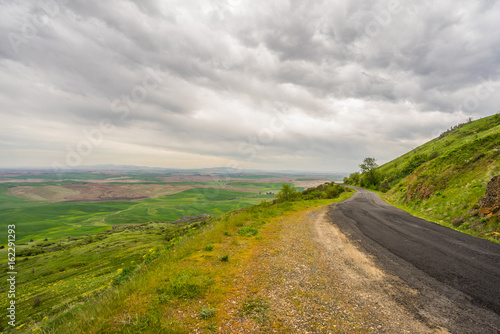 The road among green hills. Beautiful clouds over Steptoe Butte state park  Washington  USA