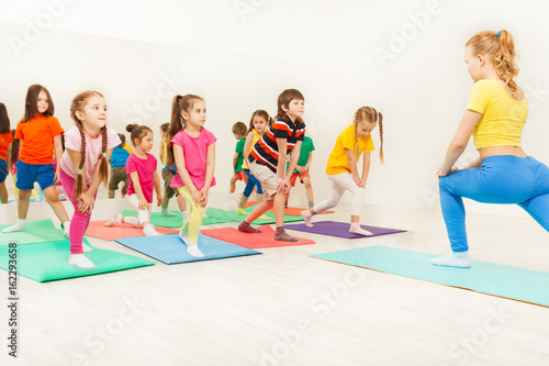 Kids doing gymnastic exercises in fitness class