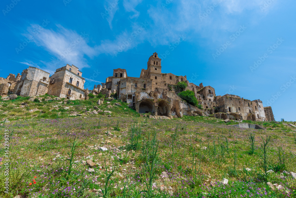 Fototapeta premium Craco (Italy) - The evocative ruins and landscapes of the ghost town scattered among the badlands hills of the Basilicata region, beside Matera, destroyed by a landslide and abandoned.