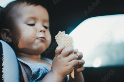 A little child eats ice cream
